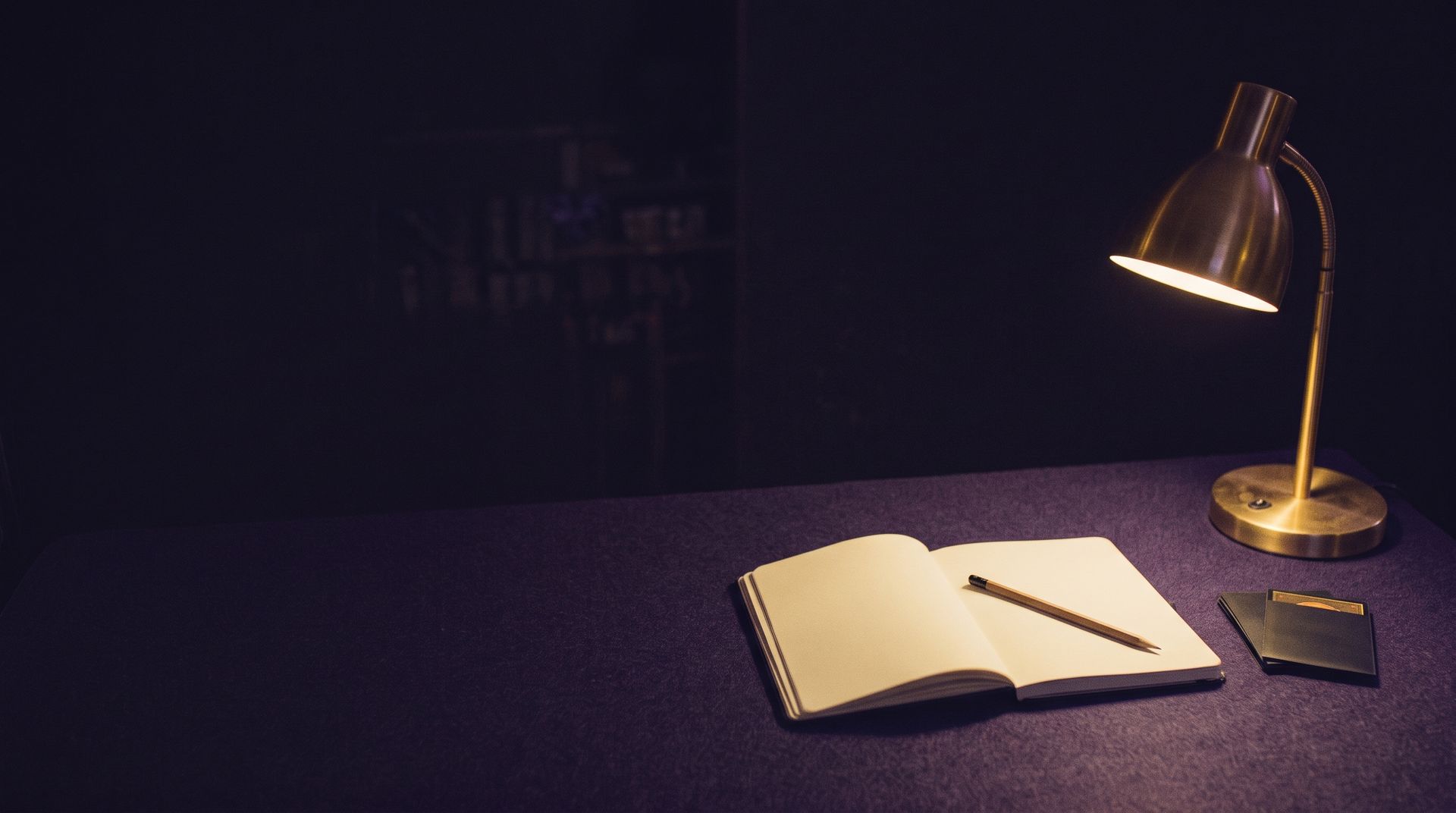 An open notebook and a sleeved card on the counter, as designed